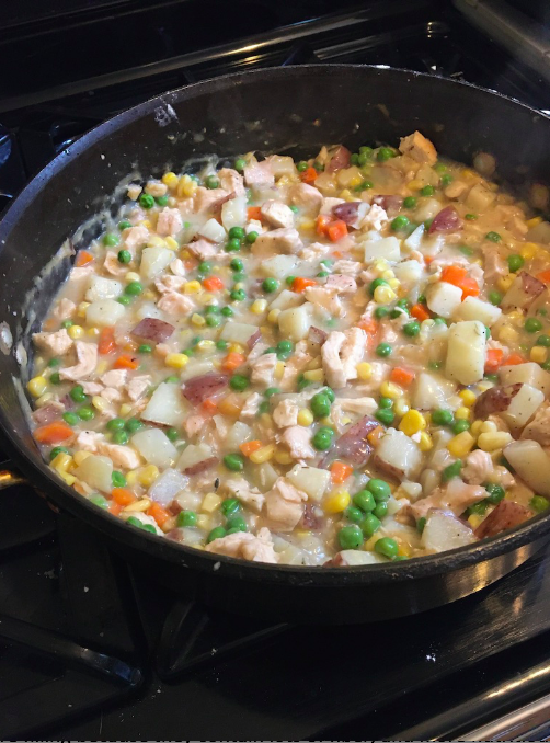 Chicken pot pie filling - pot of veggies, meat, and gravy ready for the pot pie