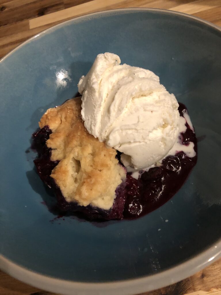 Warm blueberry cobbler and vanilla ice cream