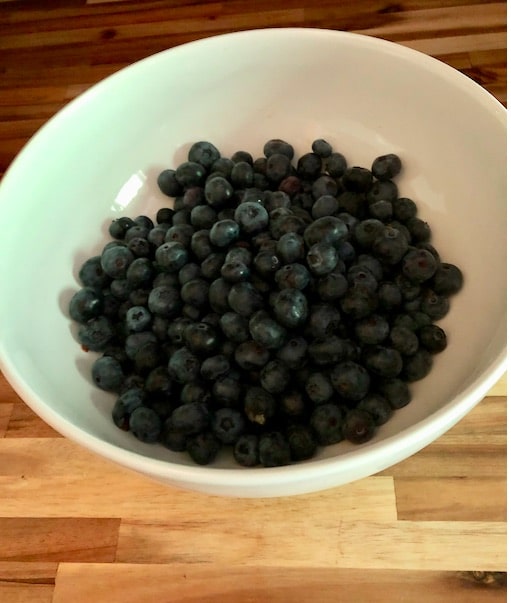 blueberries in white bowl 
