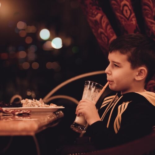 boy enjoying eating at restaurant